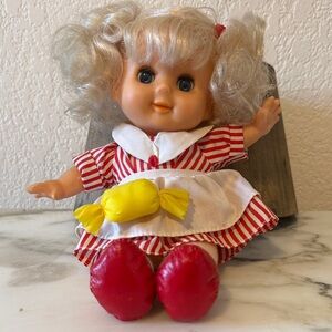 Stuffed doll in red and white striped dress